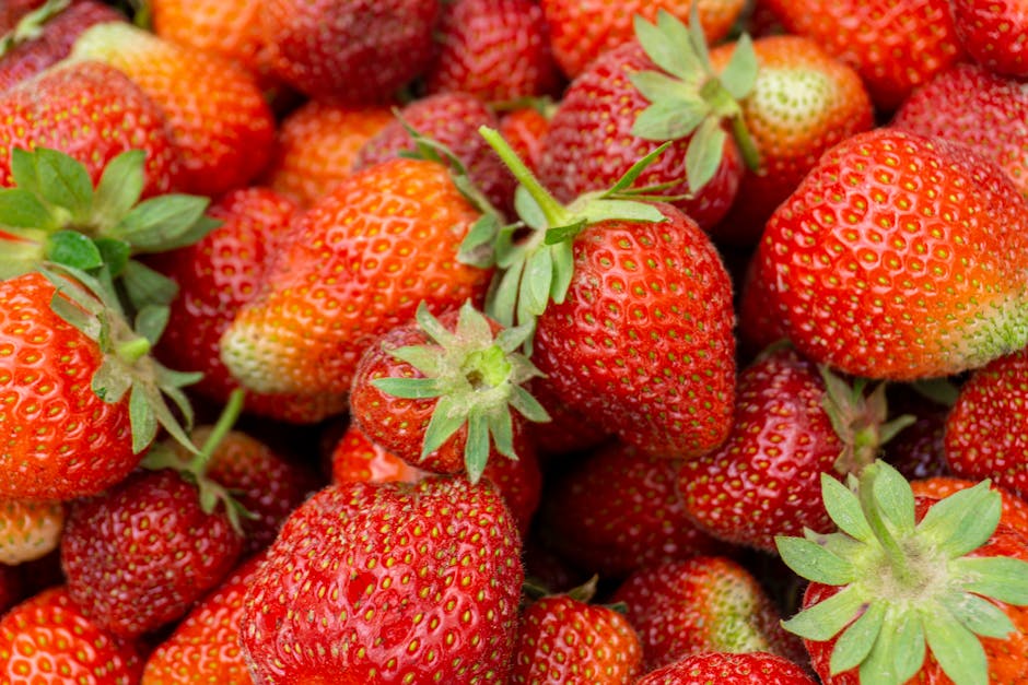 A vibrant close-up of ripe strawberries showcasing their natural texture and freshness.