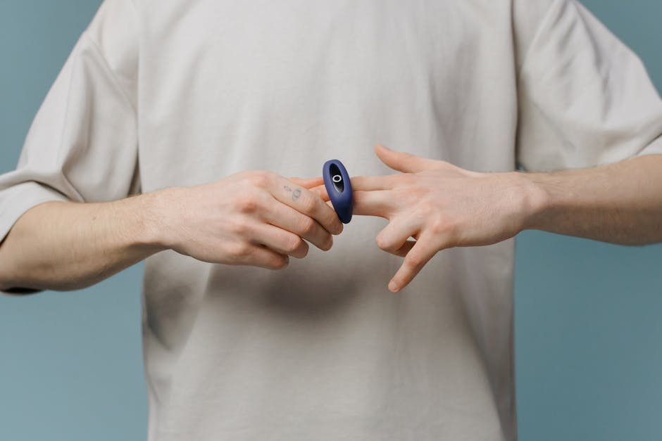 Man demonstrating a personal wellness device, focusing on body care and self-love.
