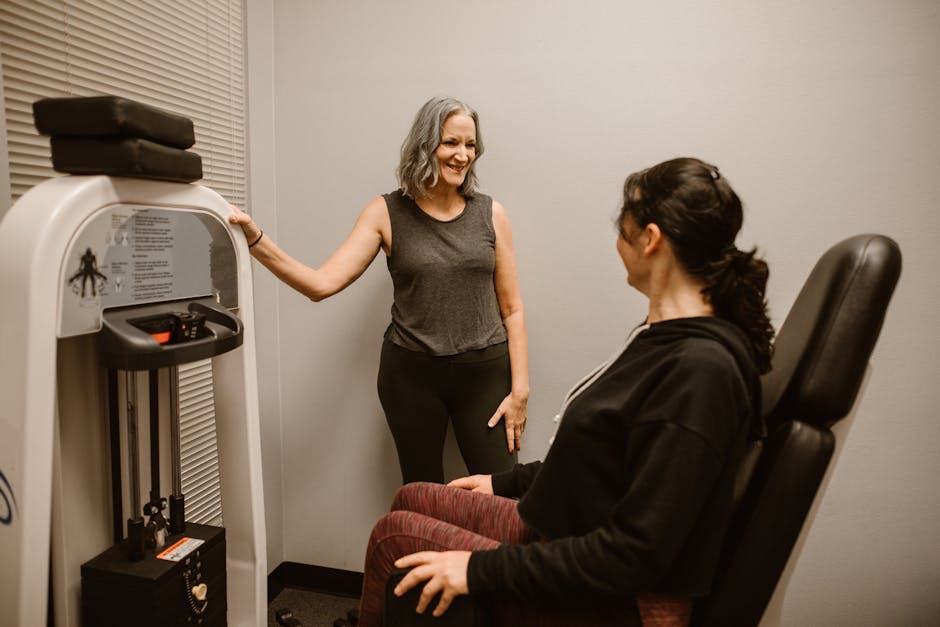 Two women exercising with gym equipment, promoting fitness and wellness indoors.