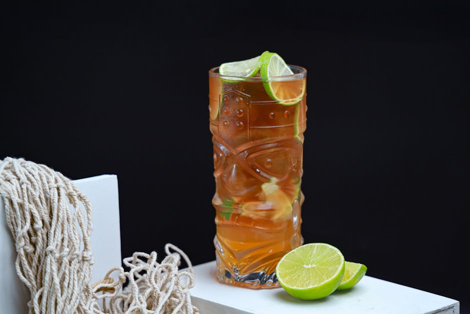 A vibrant tiki glass of lime and mint iced tea, perfect for summer refreshment.