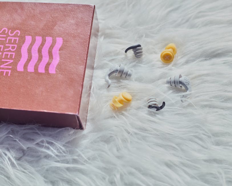 Colorful earplugs spill from a box labeled 'Serene' onto a fluffy white surface, creating a cozy vibe.