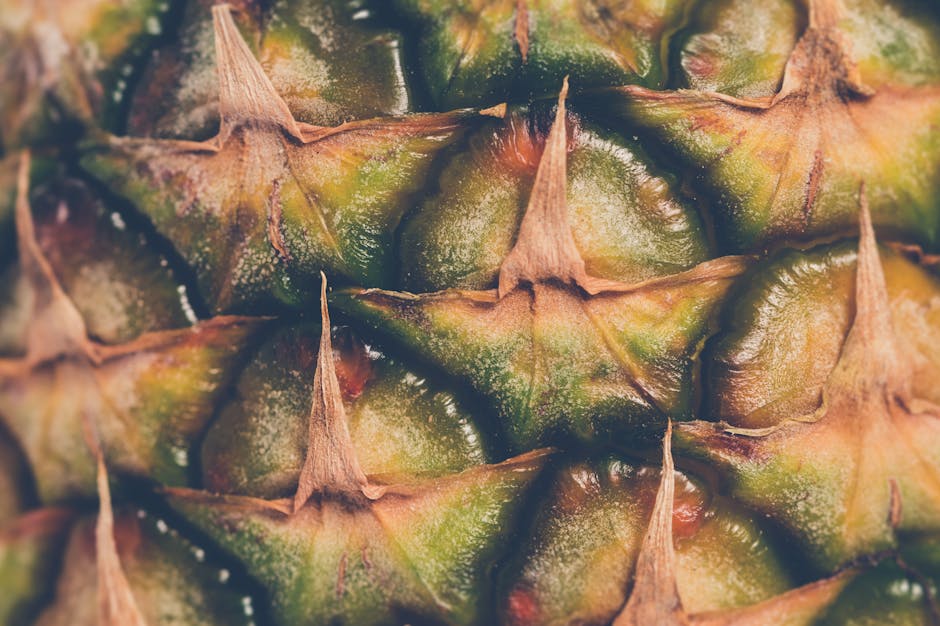 Detailed close-up image of pineapple skin showing the texture and natural patterns.