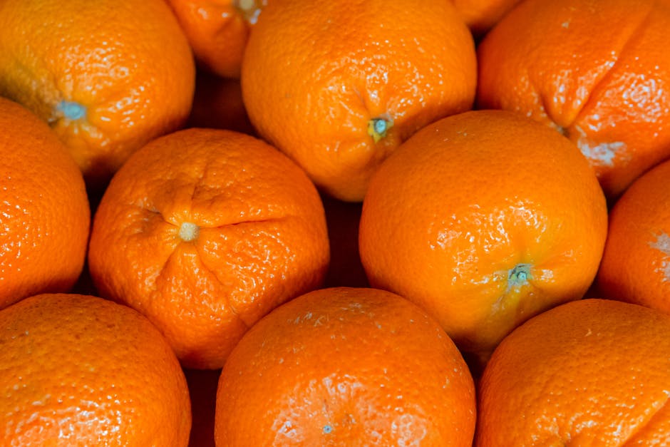 Bright closeup of fresh juicy oranges showcasing vibrant citrus texture and color.