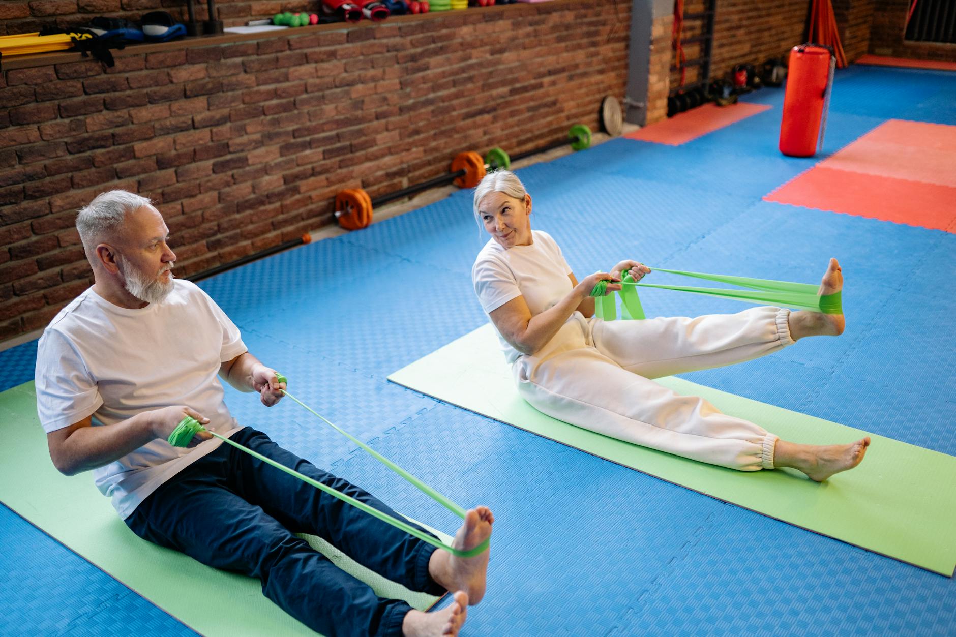 Senior couple doing resistance band exercises for bone density